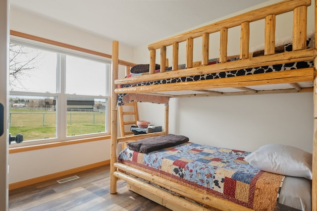 5632 Fairview Ln, Florence, MT 59833 - bedroom with baseboards, visible vents, and wood finished floors