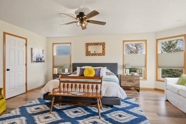 5632 Fairview Ln, Florence, MT 59833 - bedroom with baseboards, wood finished floors, and a ceiling fan