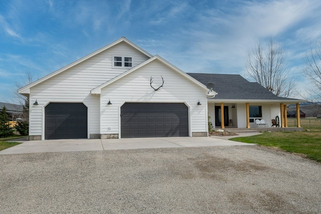 5632 Fairview Ln, Florence, MT 59833 - view of front of property with an attached garage, concrete driveway, and covered porch