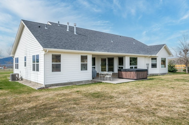 5632 Fairview Ln, Florence, MT 59833 - rear view of property with a hot tub, a shingled roof, a lawn, and a patio area