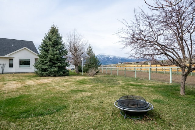 5632 Fairview Ln, Florence, MT 59833 - view of yard with an outdoor fire pit, fence, and a mountain view