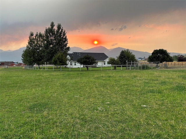 5632 Fairview Ln, Florence, MT 59833 - yard at dusk featuring a mountain view and fence