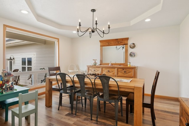5632 Fairview Ln, Florence, MT 59833 - dining area with baseboards, recessed lighting, a raised ceiling, light wood-type flooring, and an inviting chandelier