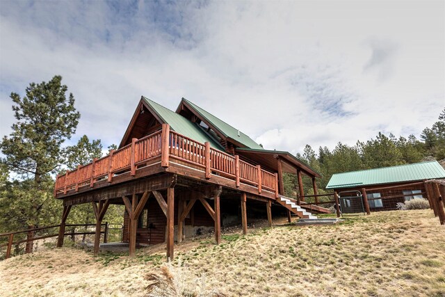 3340 Rome Ln, Stevensville, MT 59870 - back of house with metal roof and a wooden deck