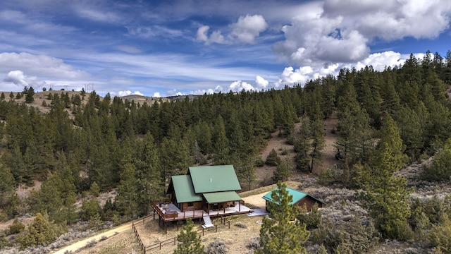 3340 Rome Ln, Stevensville, MT 59870 - view of patio with a forest view and a wooden deck