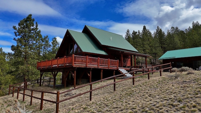 3340 Rome Ln, Stevensville, MT 59870 - rear view of house featuring metal roof and a wooded view