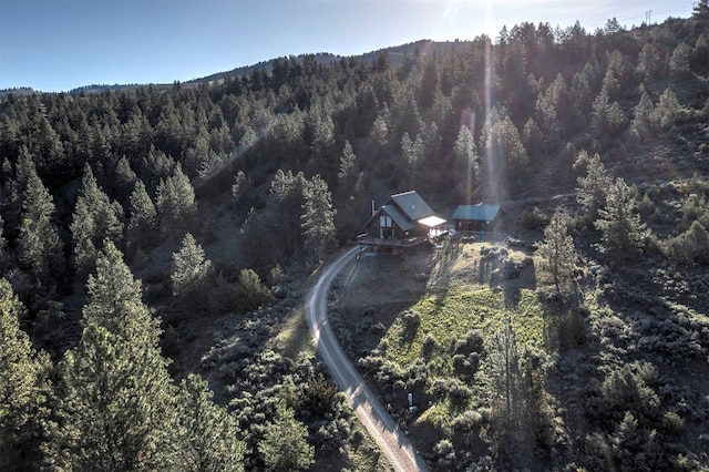 3340 Rome Ln, Stevensville, MT 59870 - aerial view of property and surrounding area with a heavily wooded area and a mountainous background