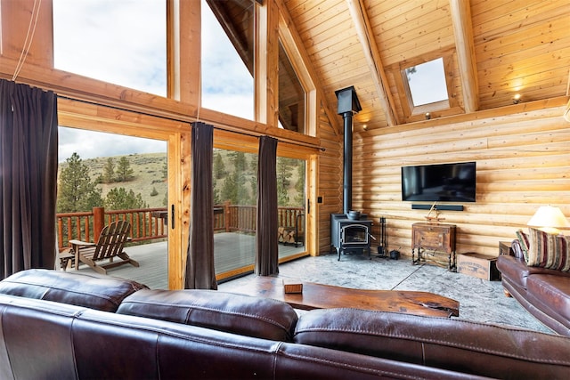 3340 Rome Ln, Stevensville, MT 59870 - living area featuring high vaulted ceiling, rustic walls, a wood stove, and wooden ceiling with exposed beams