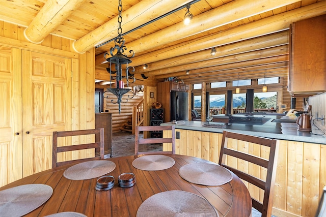 3340 Rome Ln, Stevensville, MT 59870 - dining area with hardwood / wood-style flooring, stairway, log walls, and wood ceiling with exposed beams