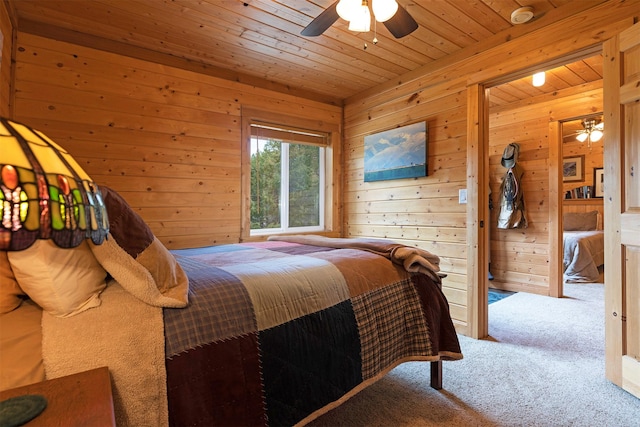 3340 Rome Ln, Stevensville, MT 59870 - carpeted bedroom featuring wooden ceiling, wood walls, and a ceiling fan