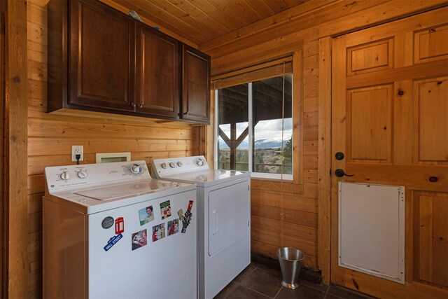 3340 Rome Ln, Stevensville, MT 59870 - washroom with washer and dryer, wooden walls, cabinet space, wood ceiling, and dark tile patterned floors