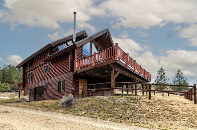 3340 Rome Ln, Stevensville, MT 59870 - rear view of property with log siding and a deck