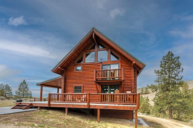 3340 Rome Ln, Stevensville, MT 59870 - back of house with log siding, a wooden deck, and a balcony