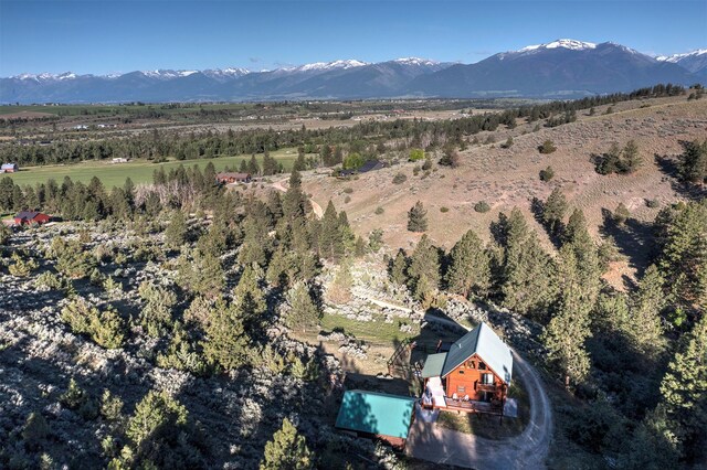 3340 Rome Ln, Stevensville, MT 59870 - aerial view of property and surrounding area featuring mountains and a pool area