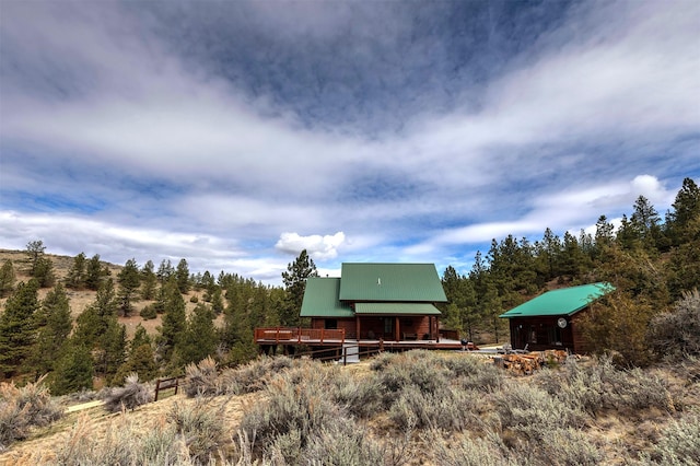 3340 Rome Ln, Stevensville, MT 59870 - rear view of property featuring metal roof and a wooden deck