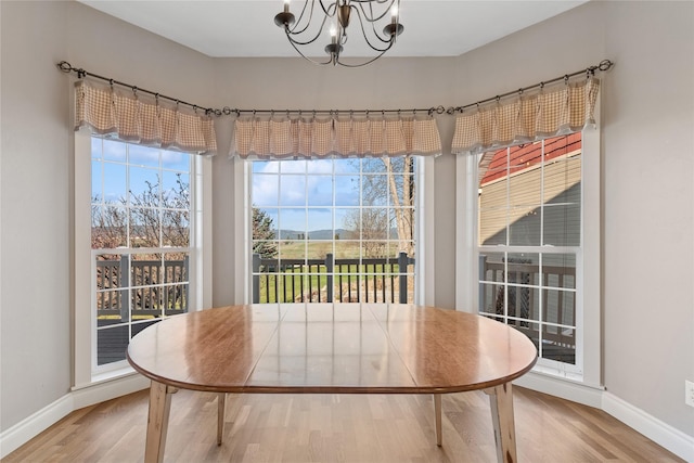266 W Bowman Dr, Kalispell, MT 59901 - dining room with wood finished floors, baseboards, and an inviting chandelier