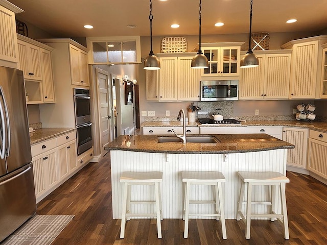 266 W Bowman Dr, Kalispell, MT 59901 - kitchen featuring a sink, glass insert cabinets, cream cabinets, appliances with stainless steel finishes, and recessed lighting