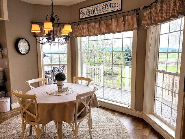 266 W Bowman Dr, Kalispell, MT 59901 - dining room with a healthy amount of sunlight, baseboards, and a notable chandelier