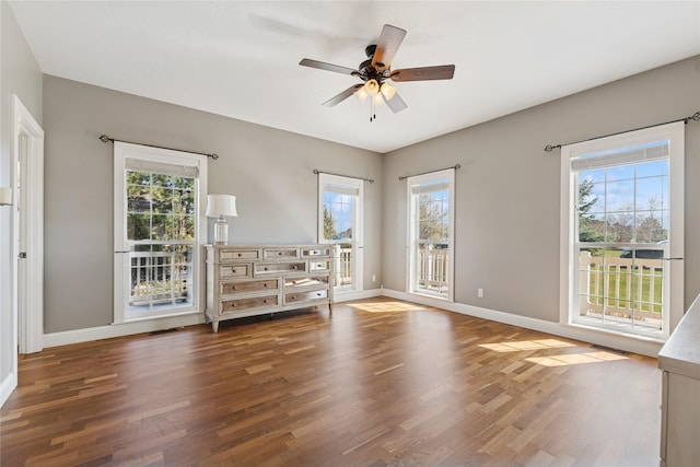 266 W Bowman Dr, Kalispell, MT 59901 - unfurnished room featuring baseboards, wood finished floors, and a wealth of natural light