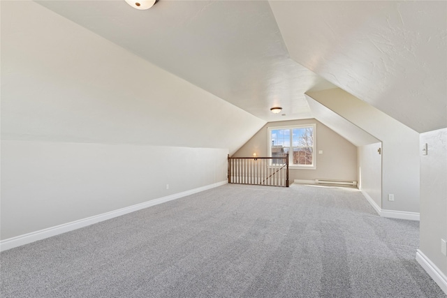 266 W Bowman Dr, Kalispell, MT 59901 - additional living space with a baseboard radiator, vaulted ceiling, carpet flooring, and baseboards