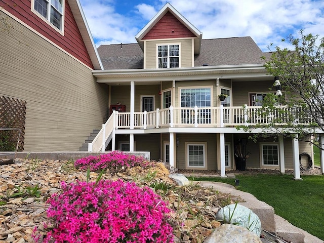 266 W Bowman Dr, Kalispell, MT 59901 - rear view of property featuring a yard, roof with shingles, and stairs