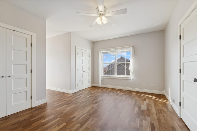 266 W Bowman Dr, Kalispell, MT 59901 - unfurnished bedroom featuring wood finished floors, baseboards, and a ceiling fan
