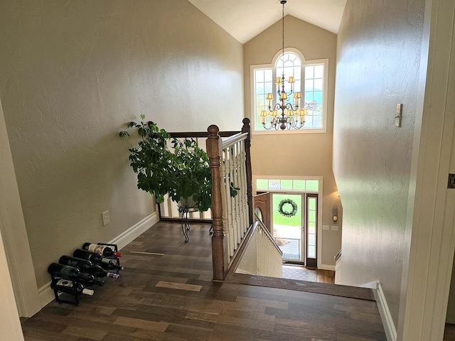 266 W Bowman Dr, Kalispell, MT 59901 - entryway with high vaulted ceiling, wood finished floors, baseboards, and a notable chandelier