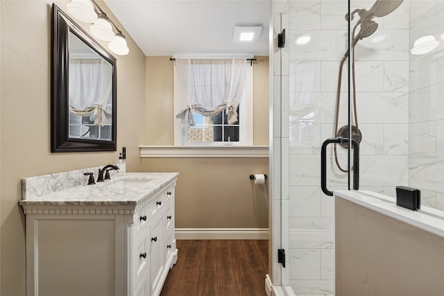 266 W Bowman Dr, Kalispell, MT 59901 - bathroom featuring baseboards, wood finished floors, vanity, and tiled shower