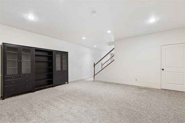 266 W Bowman Dr, Kalispell, MT 59901 - unfurnished living room with baseboards, carpet, stairs, and recessed lighting
