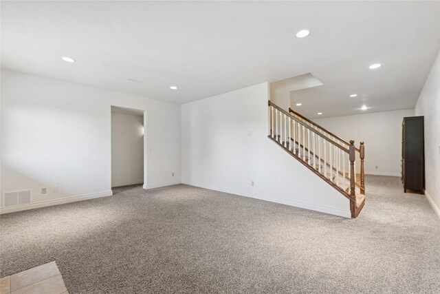 266 W Bowman Dr, Kalispell, MT 59901 - unfurnished living room with light carpet, baseboards, visible vents, recessed lighting, and stairway
