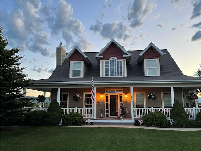 266 W Bowman Dr, Kalispell, MT 59901 - view of front of home with a lawn, a chimney, and covered porch