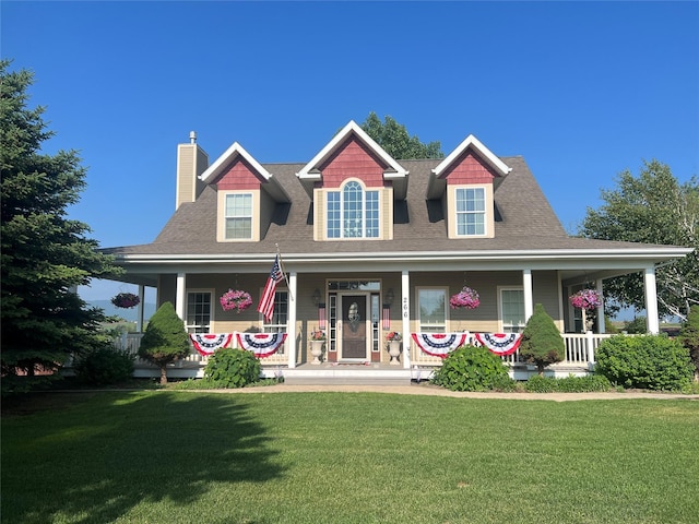 266 W Bowman Dr, Kalispell, MT 59901 - farmhouse inspired home featuring a chimney, a front lawn, and a porch