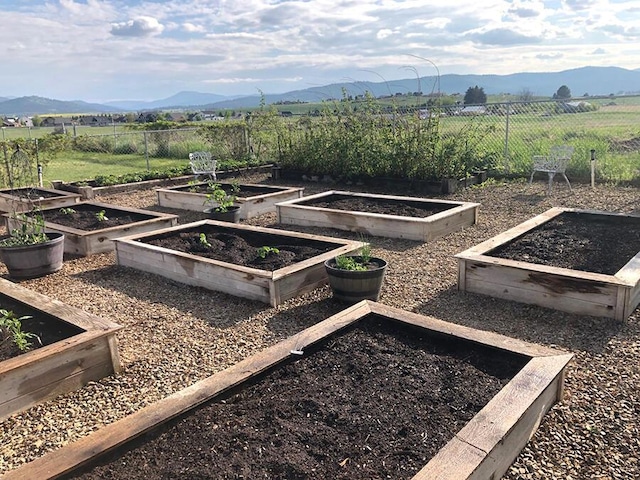 266 W Bowman Dr, Kalispell, MT 59901 - view of yard featuring fence, a rural view, a garden, and a mountain view