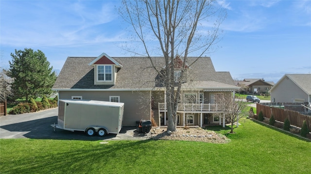 266 W Bowman Dr, Kalispell, MT 59901 - rear view of property featuring a lawn, fence, and a shingled roof