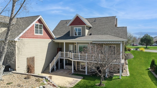 266 W Bowman Dr, Kalispell, MT 59901 - rear view of property featuring roof with shingles, a patio area, a lawn, stairway, and a deck
