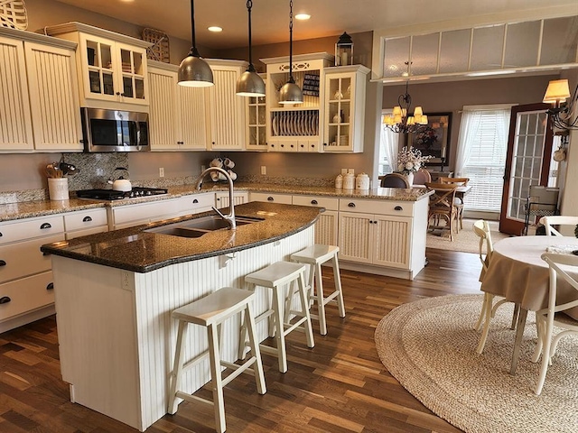 266 W Bowman Dr, Kalispell, MT 59901 - kitchen featuring a sink, cream cabinets, stainless steel microwave, a notable chandelier, and recessed lighting