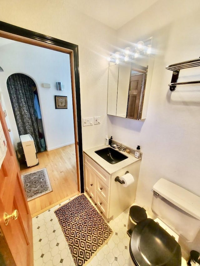 26134 Spinnaker Ln, Elmo, MT 59915 - half bath featuring tile patterned floors, toilet, and vanity