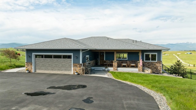 160 Quirk Trl, Eureka, MT 59917 - view of front facade featuring a porch, an attached garage, stone siding, and asphalt driveway