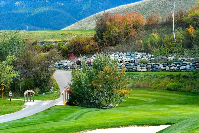 160 Quirk Trl, Eureka, MT 59917 - view of property's community with a mountain view, a lawn, and golf course view