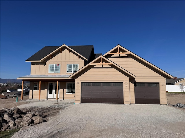 160 Kara Dr, Kalispell, MT 59901 - craftsman-style house with board and batten siding, an attached garage, driveway, and a porch
