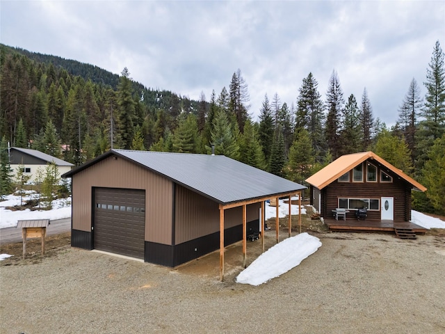 37 Rudolph Ct, Haugan, MT 59842 - rear view of house featuring metal roof, a deck, and a forest view