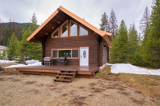 37 Rudolph Ct, Haugan, MT 59842 - view of front facade featuring a detached garage, a wooded view, a wooden deck, an outbuilding, and metal roof