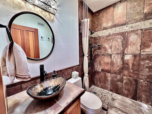 93 Golf Course Dr, Ennis, MT 59729 - full bathroom with a tile shower, a textured wall, and vanity