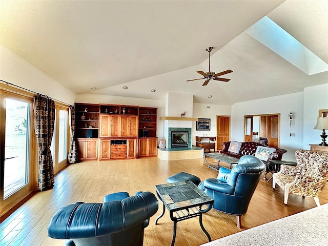 93 Golf Course Dr, Ennis, MT 59729 - living room with healthy amount of natural light, ceiling fan, a glass covered fireplace, light wood-type flooring, and high vaulted ceiling
