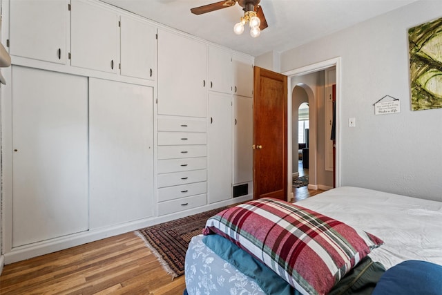620 Stephens Ave, Missoula, MT 59801 - bedroom with arched walkways, wood finished floors, a closet, and ceiling fan