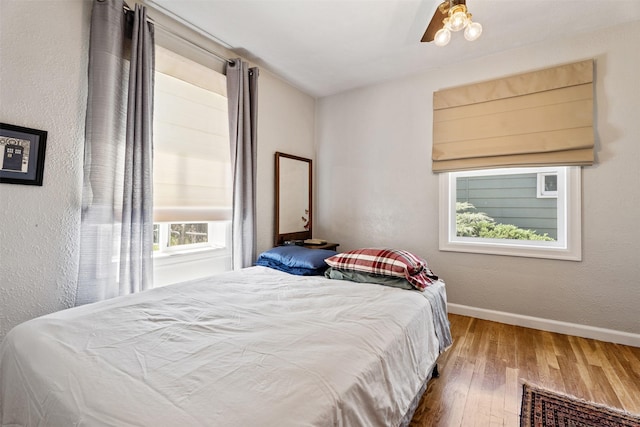 620 Stephens Ave, Missoula, MT 59801 - bedroom with wood-type flooring, baseboards, ceiling fan, and a textured wall