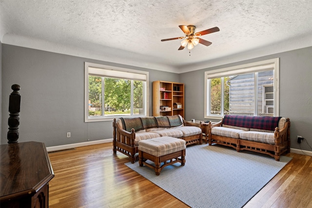 620 Stephens Ave, Missoula, MT 59801 - living room featuring a ceiling fan, wood finished floors, baseboards, and a textured ceiling