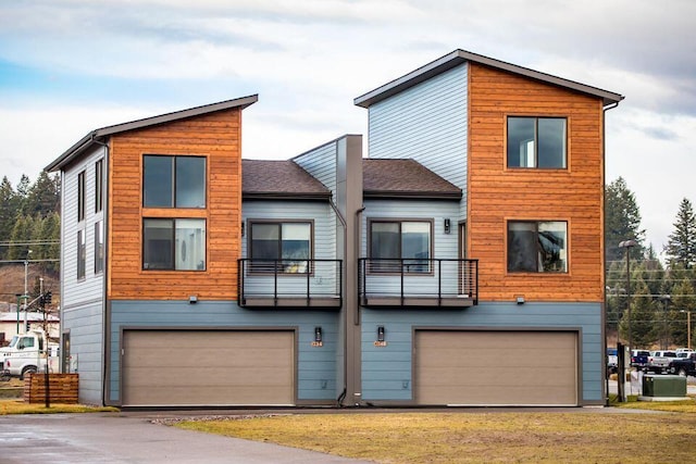 21D Hickory Loop, Whitefish, MT 59937 - view of front of home with a garage, a balcony, and a shingled roof