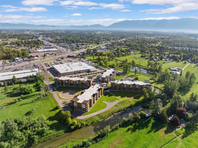 drone / aerial view featuring a water and mountain view