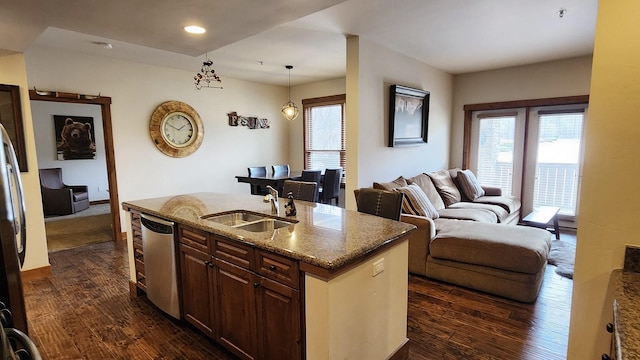6104 Monterra Ave Unit L, Whitefish, MT 59937 - kitchen with appliances with stainless steel finishes, stone countertops, dark wood-style floors, a kitchen island with sink, and recessed lighting